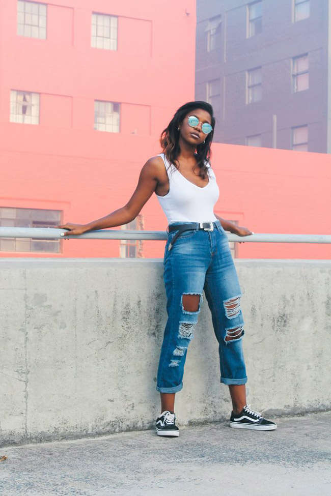 Donna dons a classic white shirt-blue jean look, with a street style flare.