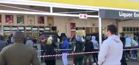 South Africans sing as they line up for liquor
