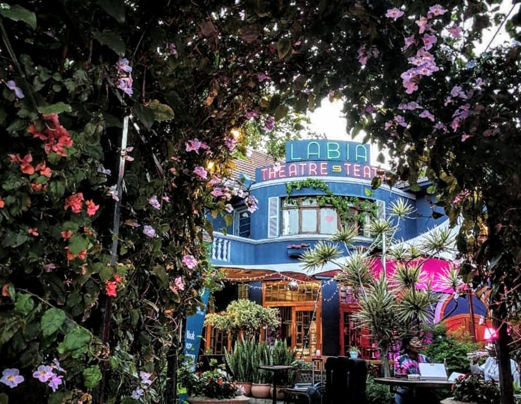Quaint Labia Theatre nestled amidst lush gardens in Cape Town, offering an offbeat cinematic experience and a cozy ambiance for movie enthusiasts looking for unusual things to do in Cape Town.