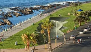 Artist spray paints mural of hope and dialogue on Sea Point promenade