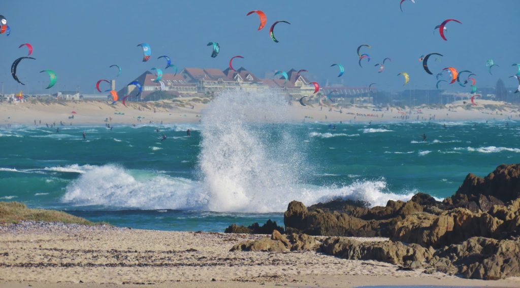 Look! A rainbow of kitesurfers fill the sky in Table View