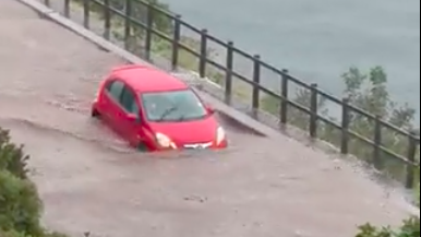 Watch: Vehicle making its way through flash-flooded road