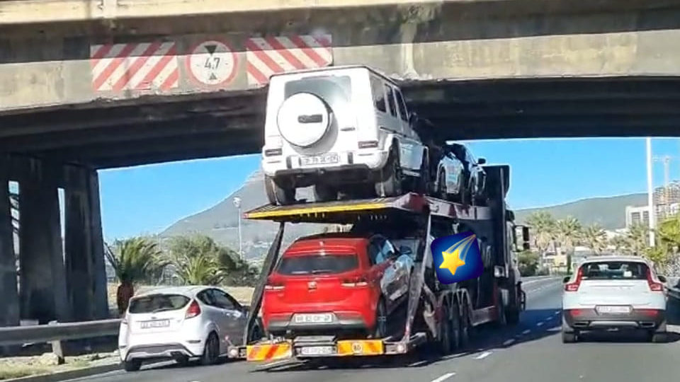 Look: Questions raised as truck with luxury cars gets stuck under bridge