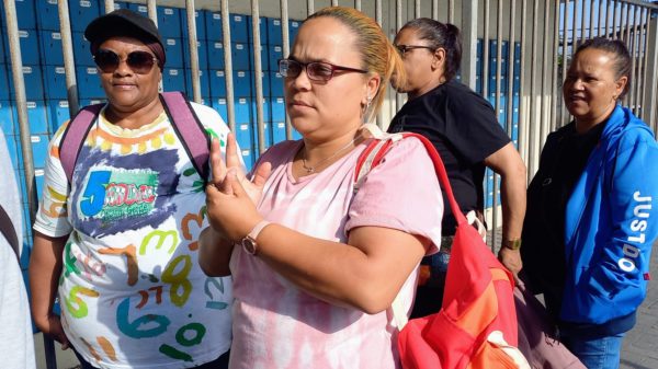 Yolanda Lawrence (left) and Angelina Stuurman (right) were among dozens of grant beneficiaries waiting outside the Athlone Post Office on Tuesday.