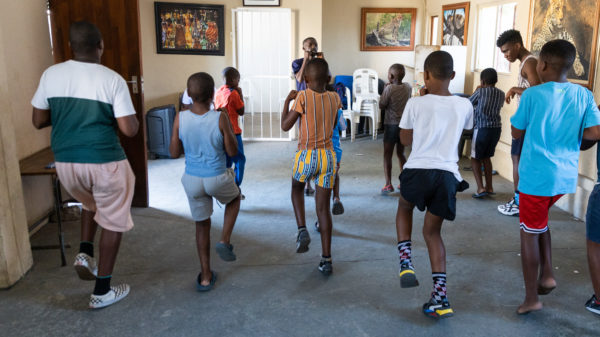 Coach Athi Msindeli teaches children to stretch and get fit at the Sosebenza youth centre.