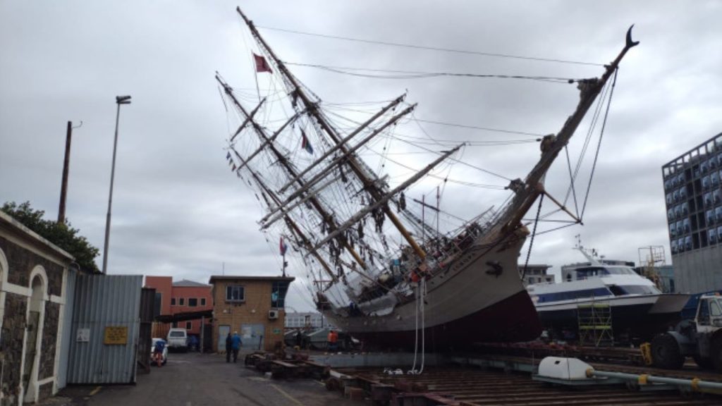 A century-old ship capsized in Cape Town Waterfront, injuring one sailor
