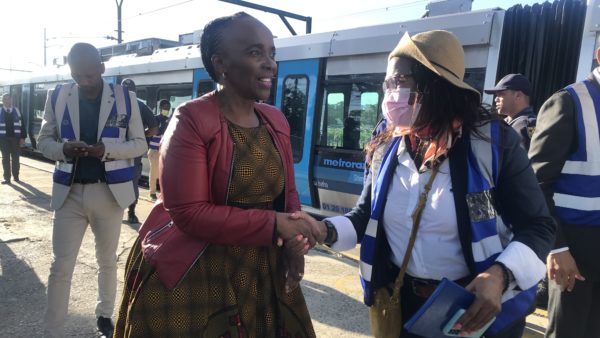 Minister of Transport Sindisiwe Chikunga shakes hands with Metrorail spokesperson Zinobulali Mihi at Eerste River station. Photo: Tariro Washinyira