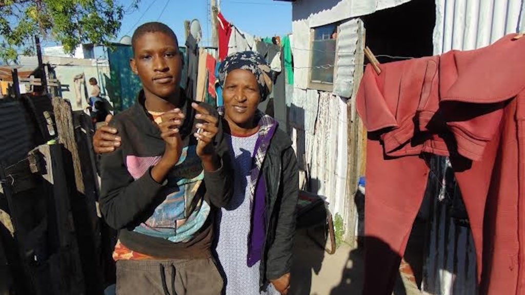 Ten years after GroundUp revealed her plight, a disabled woman and her autistic son are still living in a tiny shack with no electricity or sanitation
